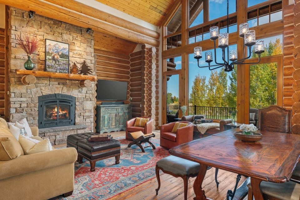 Unwind in this stunning log cabin retreat where rustic charm meets luxury comfort. Cozy up by the stone fireplace while enjoying mountain views through soaring windows.
