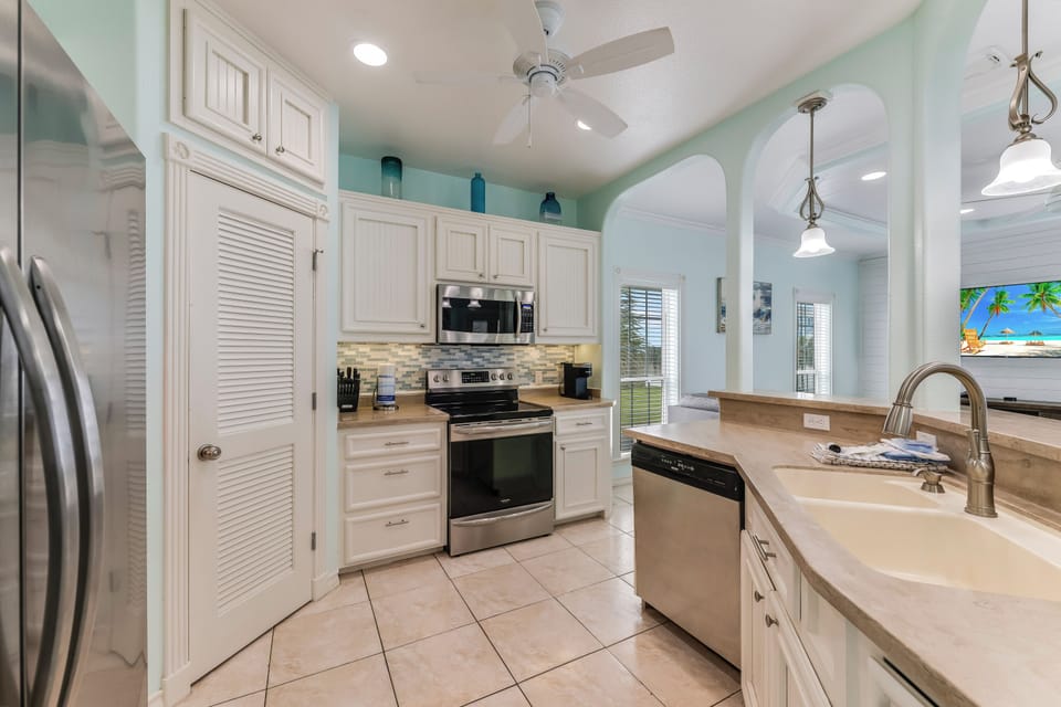 Cook your favorite meals in this bright, fully equipped kitchen with stainless steel appliances and ample counter space for all your culinary adventures.