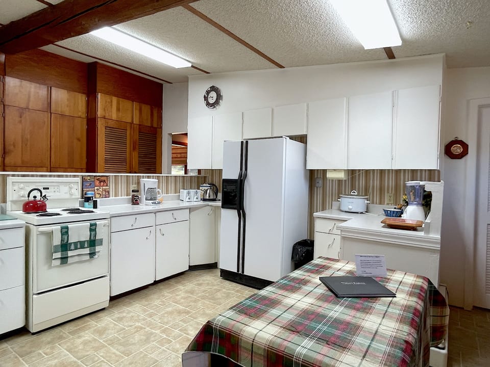 The kitchen is bright with ample cabinet and countertop space for preparing meals