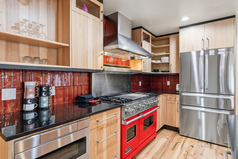 Kitchen: Viking appliances, drip coffee maker, Keurig, cooking utensils, tableware, bar seating