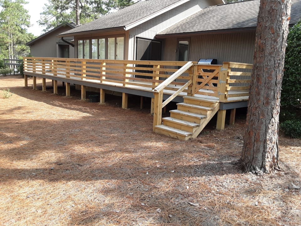 back of house with new deck