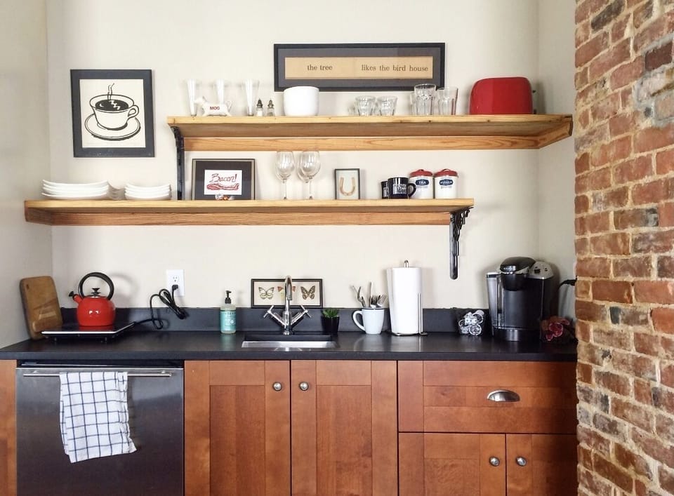 Kitchenette contains a small fridge, hot plate, toaster oven.  