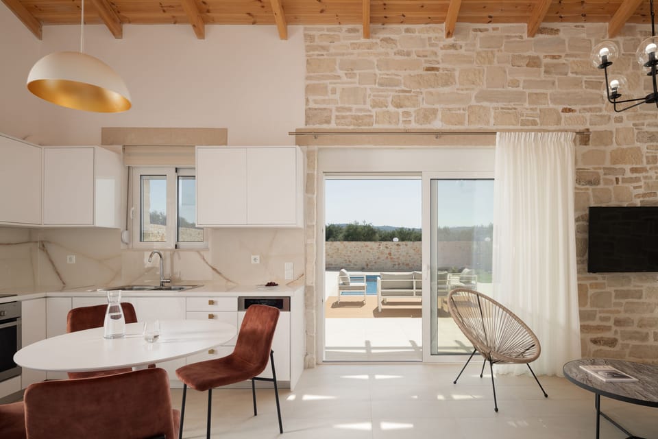 The modern open-plan living space includes a dining area.