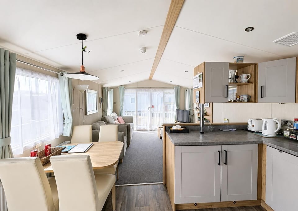 The open-plan lounge and modern kitchen create the perfect hub for your family holidays on the beautiful Suffolk coast