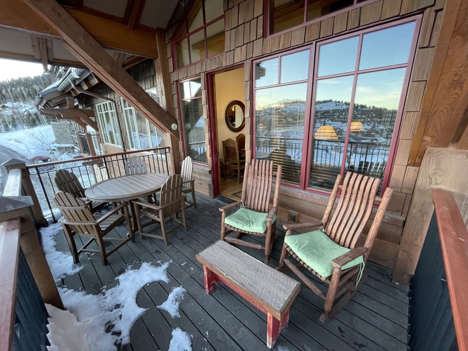 Dining table and chairs and comfortable rockers on the balcony to enjoy the view