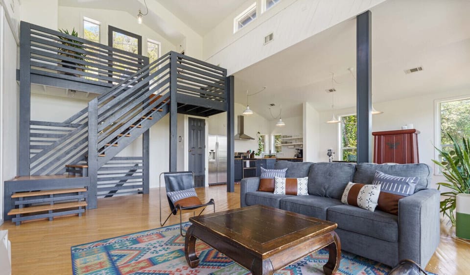 Living room with gorgeous windows, smart tv, and sleeper sofa