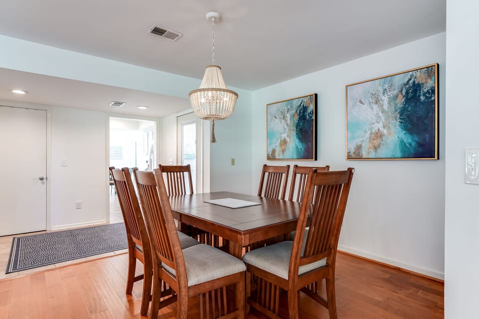 Dining area seating for 8 with hard wood floors.