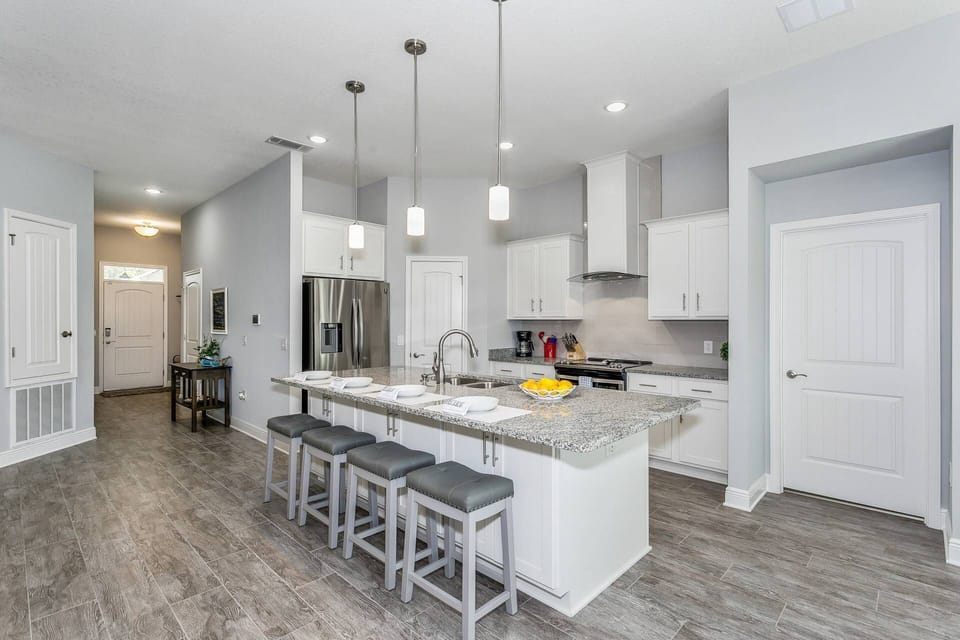 The oversized kitchen island is the perfect spot for family breakfast or getting some work done