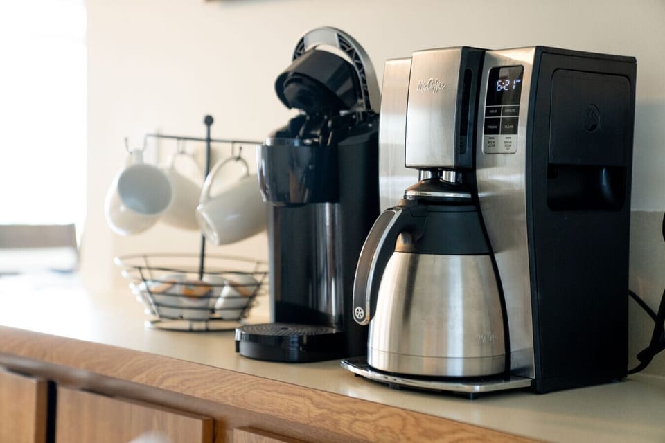 Coffee bar with both a drip coffee maker and Keurig machine.
