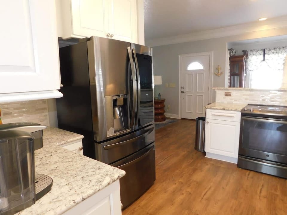 Bright, modern kitchen with spacious granite countertops and stainless steel appliances