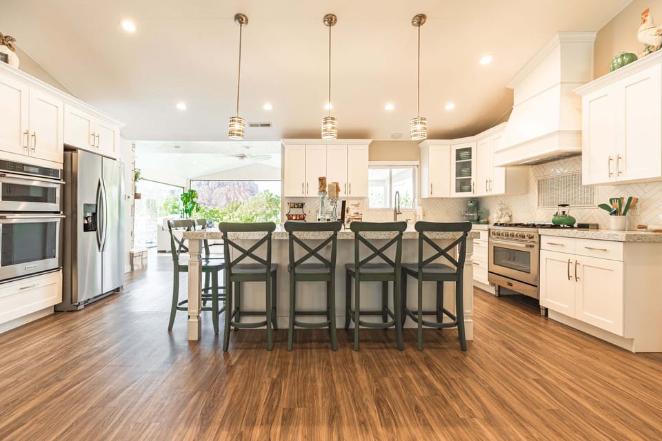 The kitchen on the main level offers 2 separate ovens + gas burner stovetop
