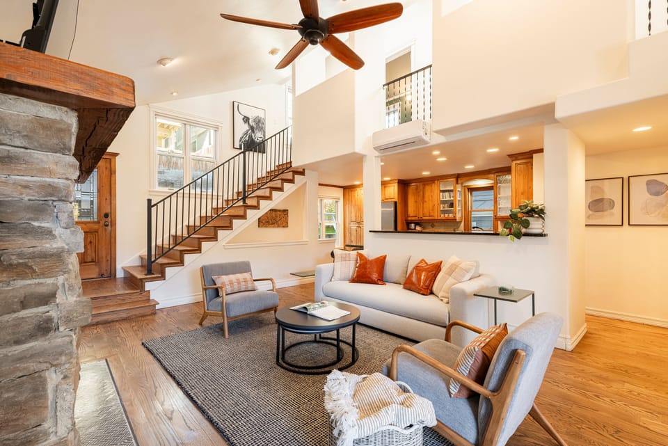 Living Room with 48" Smart TV, gas fireplace, plush furnishings, and Private BBQ patio access