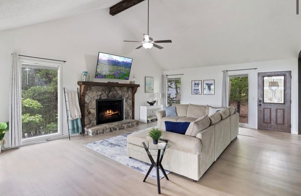 Living area with large windows, smart TV, and lake views