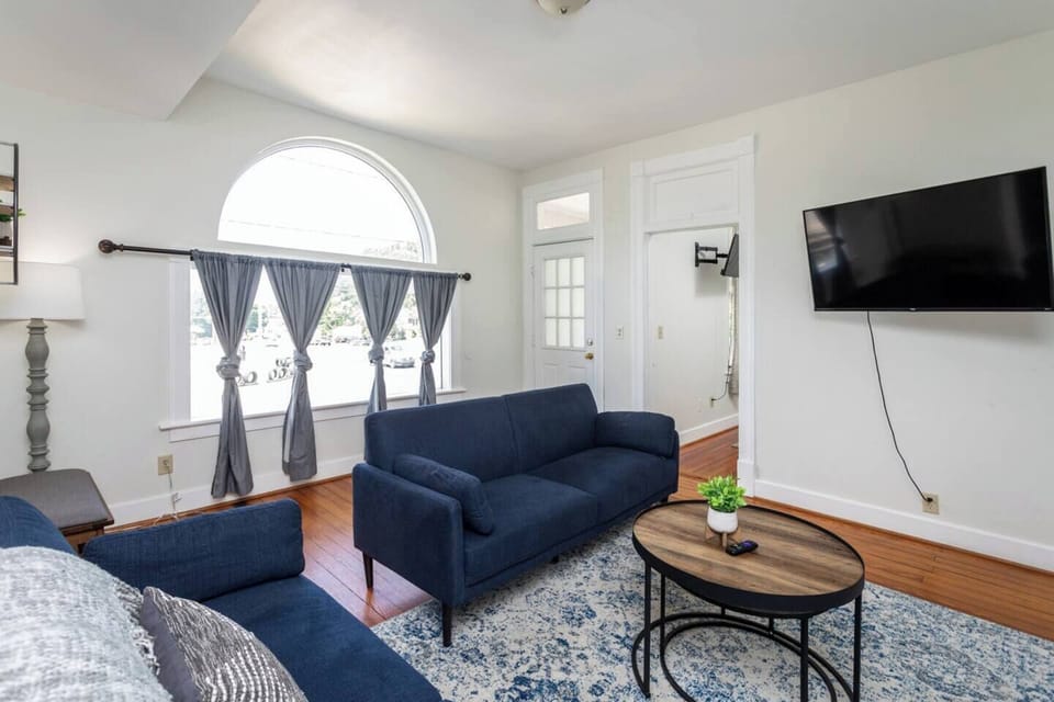 Spacious living area with flat-screen TV, sofa, and WIFI/NETFLIX provided. Sofa for sleeping an additional guest.