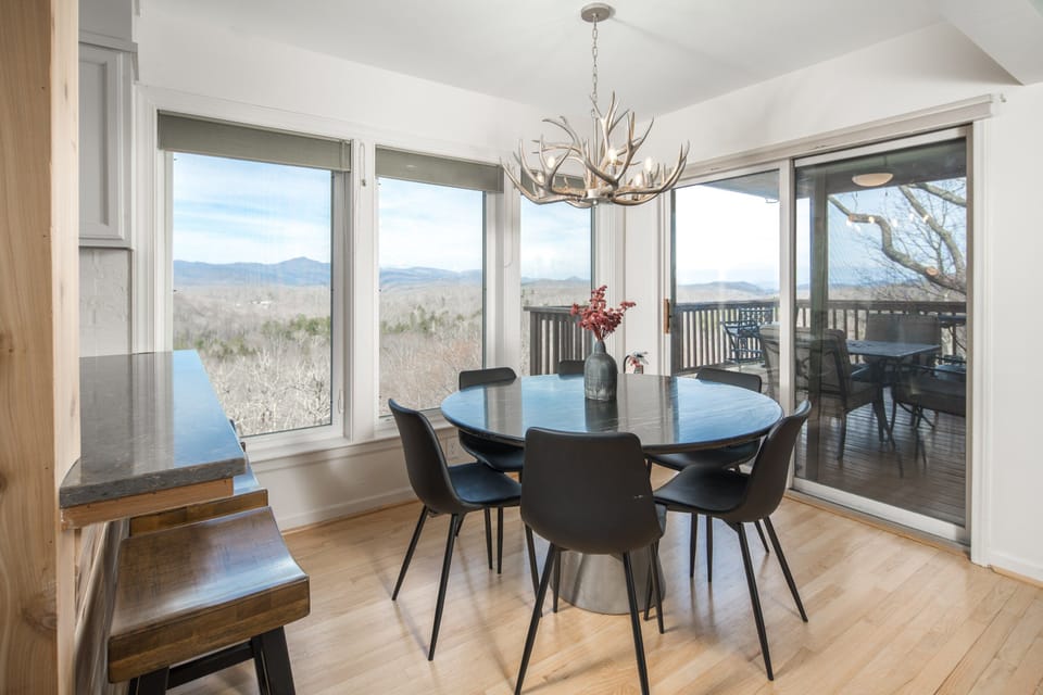 Gather around the table with easy deck access and mountain views just beyond.