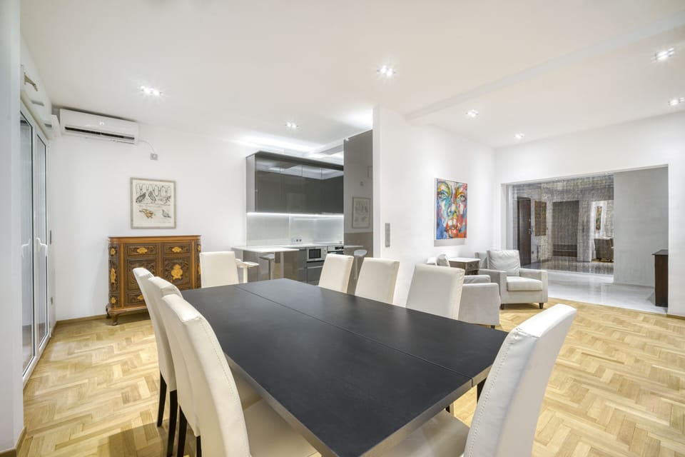 Dining area with separate bar area opening to kitchen and balcony