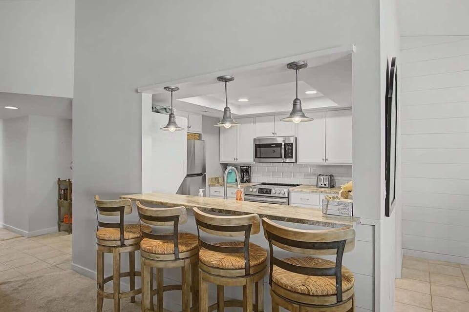 Your fully equipped kitchen features a breakfast bar where you can enjoy morning coffee while planning your day's adventures.