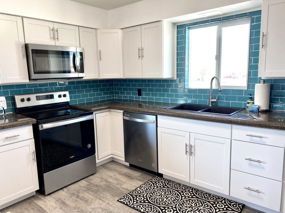 All new kitchens in both homes. Beautiful beach glass backsplash & stainless app