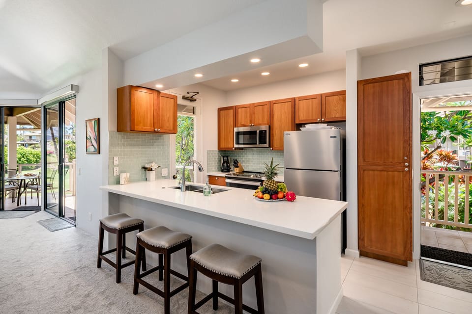 Bright kitchen with breakfast bar and stainless steel appliances