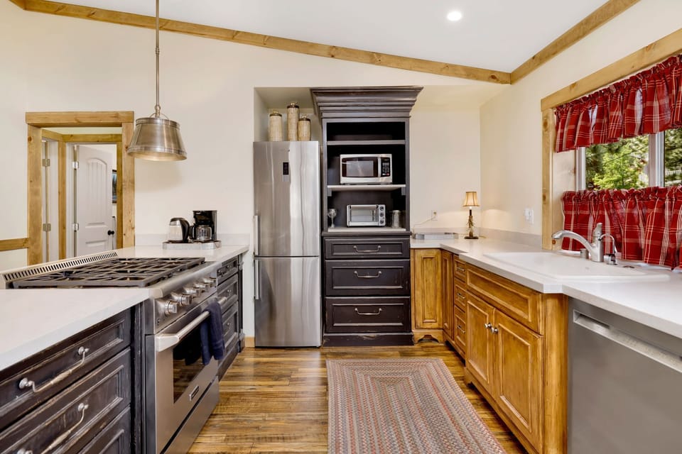 Fully equipped cabin kitchen with ample cabinetry, stove, fridge, microwave, and coffee maker—perfect for cooking meals, morning coffee, and feeling right at home on your stay.
