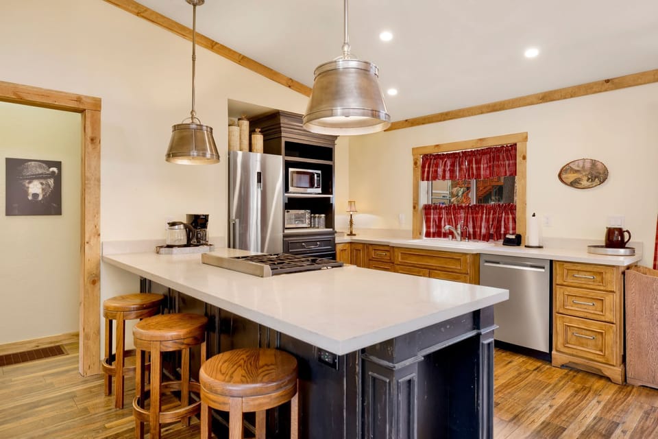 Fully equipped cabin kitchen with ample cabinetry, stove, fridge, microwave, and coffee maker—perfect for cooking meals, morning coffee, and feeling right at home on your stay.