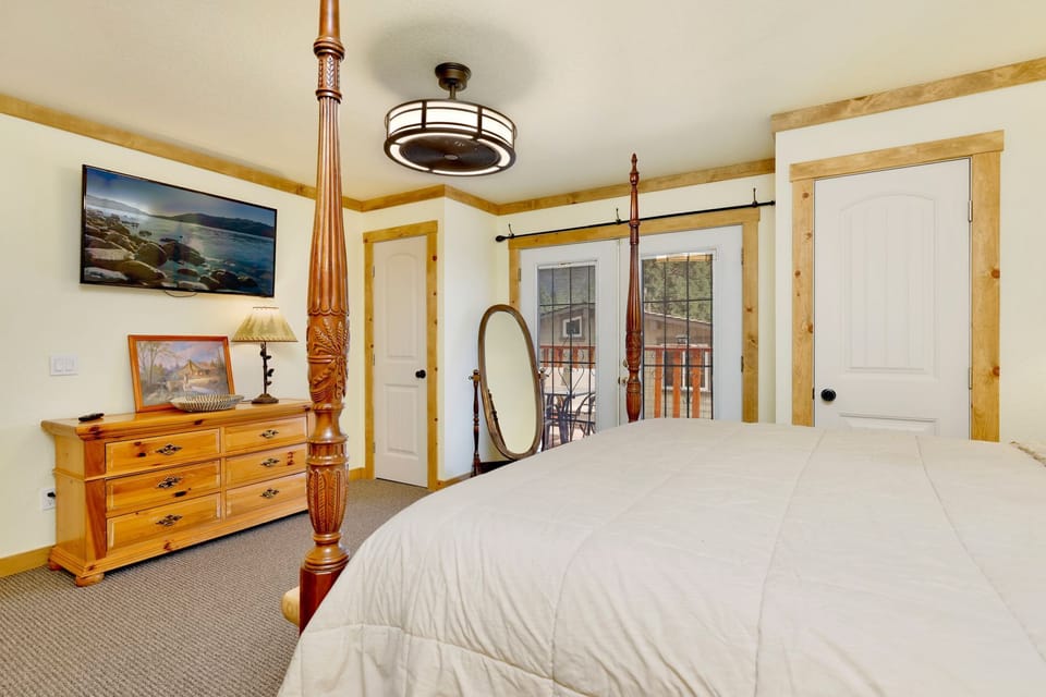 Peaceful cabin bedroom with plush bedding, and beautiful views—ideal for restful nights, cozy mornings, and a relaxing mountain escape.