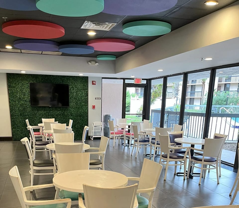 Sip coffee in a sunlit lounge with plenty of seating.
