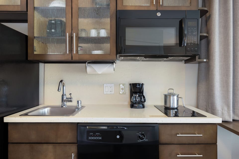 Brew coffee and prep meals with sink, stove, and microwave.