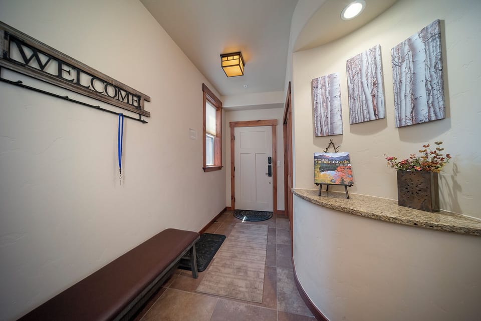 Step into your welcoming entryway where birch tree artwork and thoughtful touches create an immediate sense of home and relaxation.