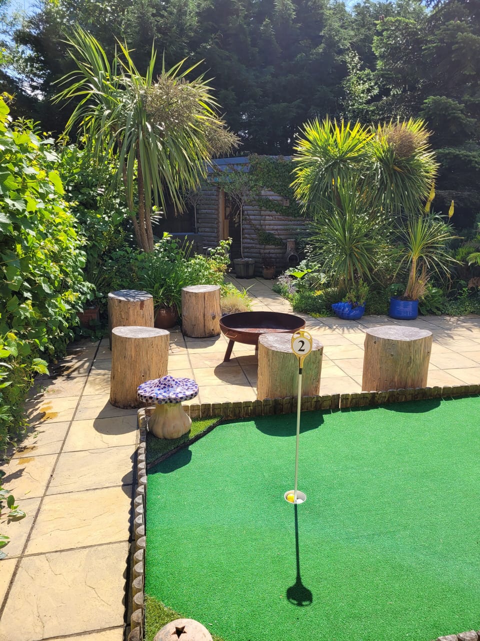 Mini golf, firepit and sauna in the background