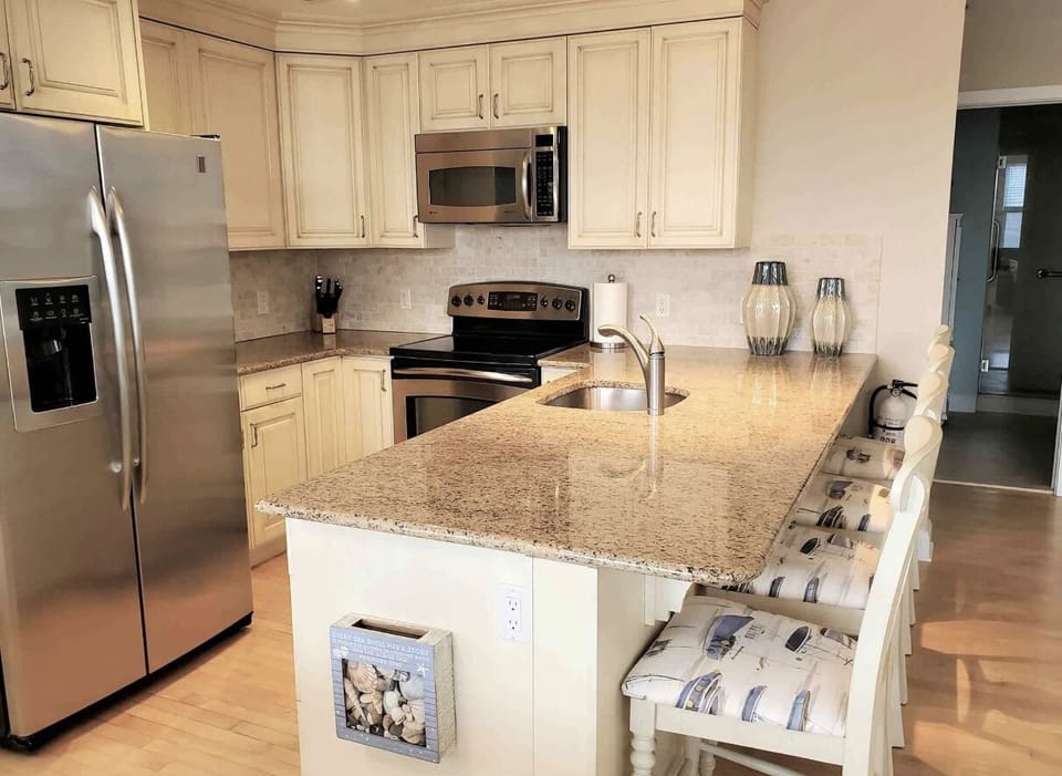 Kitchen - with stainless steel appliances and granite countertops.   