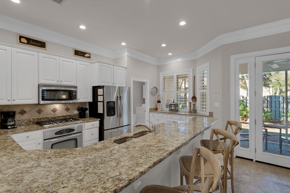 Large kitchen with separate pantry and pass-through to screened porch.