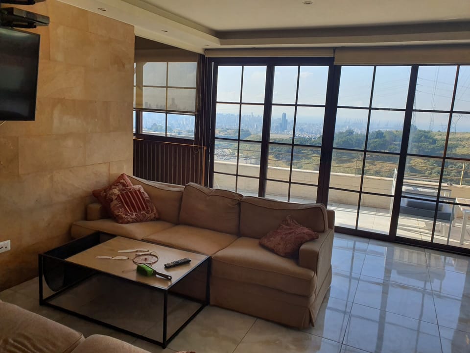 living room with city and mountain view 