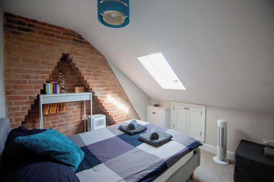 Double bedroom with clothes hanger, hair dryer and air con plus fan for the warmer evenings! Bedside table with small reading lamp and some books.