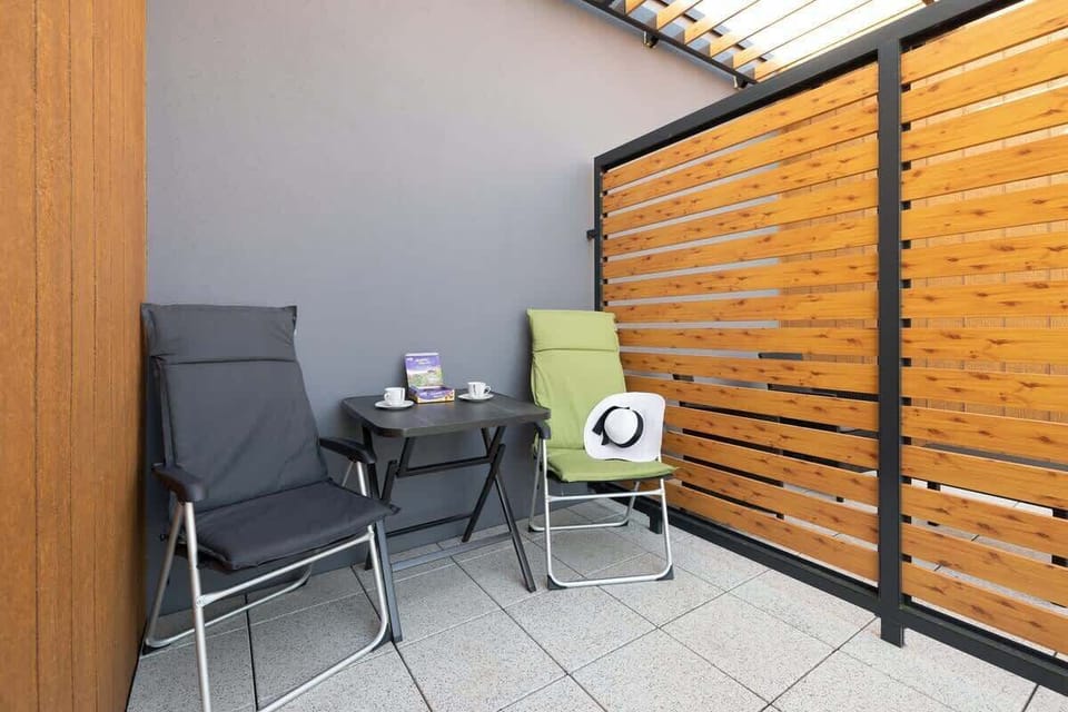 Furnished balcony provides a functional space.
