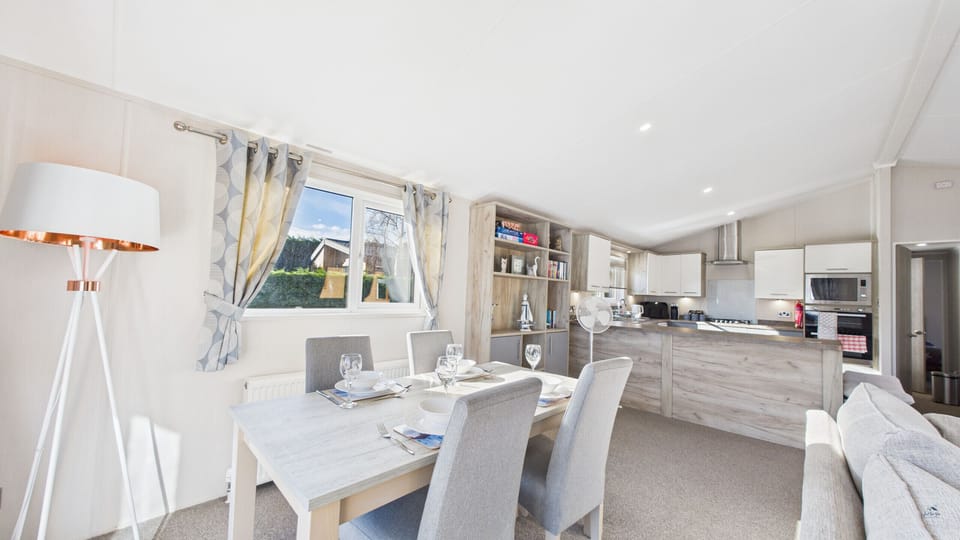This perspective shows the seamless flow between the dining space and the living area for a social holiday.