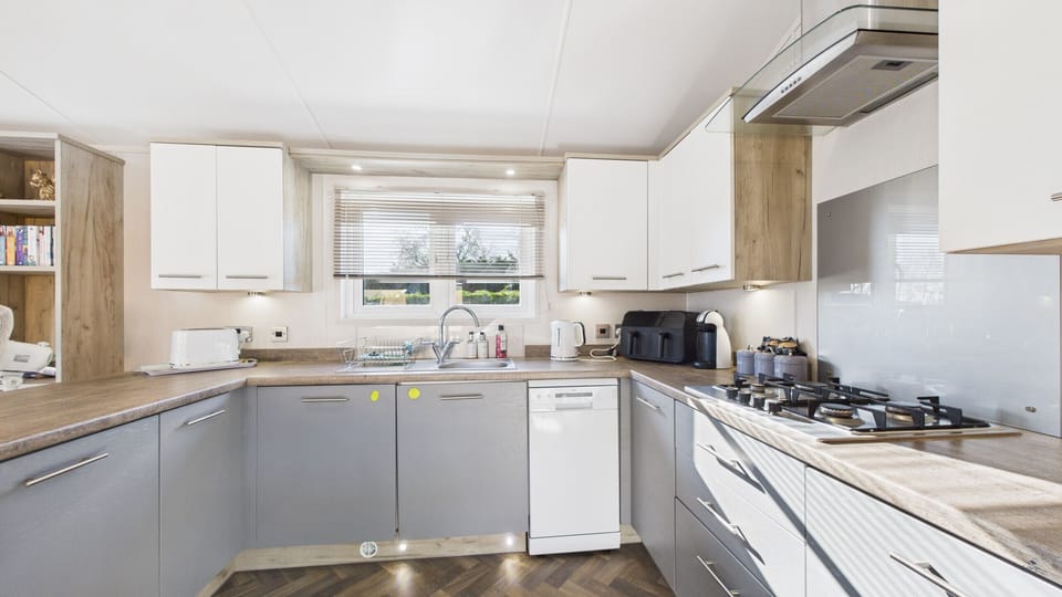 A second angle highlighting the breakfast bar and ample food prep space.