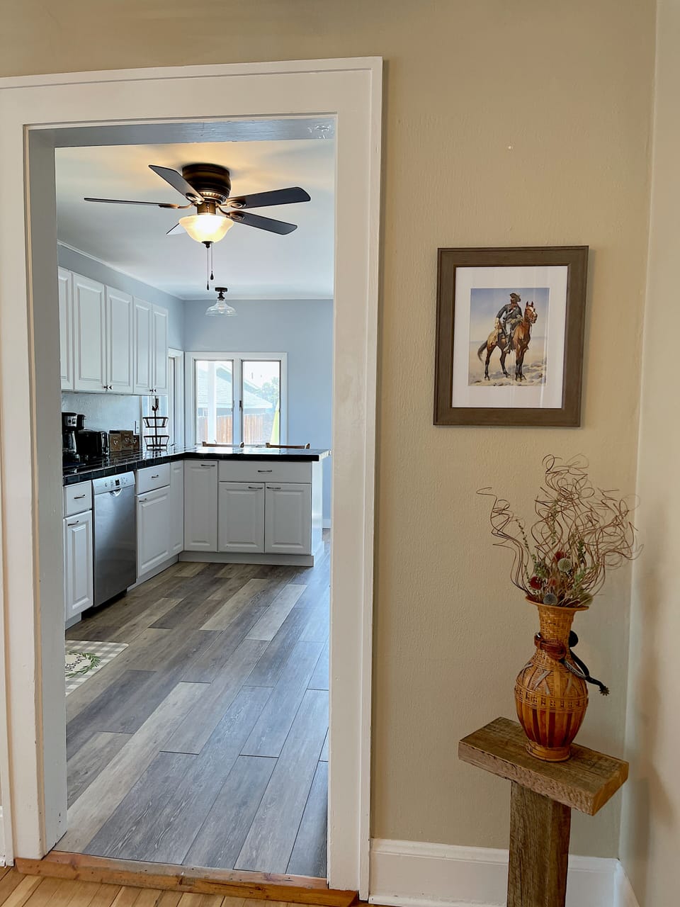 Natural light fills the space, including this view from the dining room into the kitchen