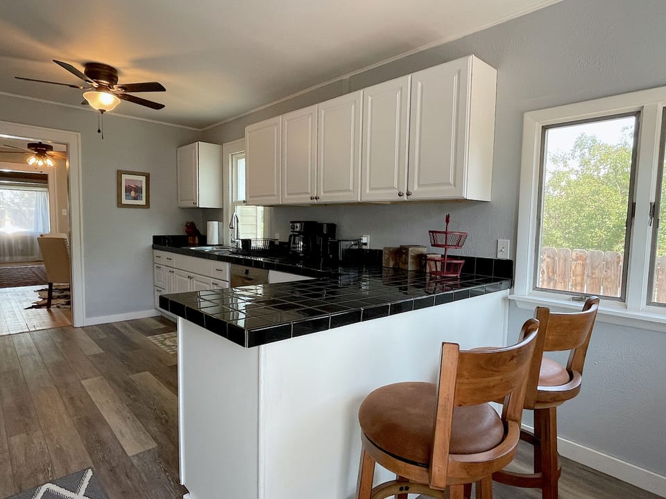 The roomy kitchen is equipped for easily preparing meals or enjoying your morning coffee at the breakfast bar