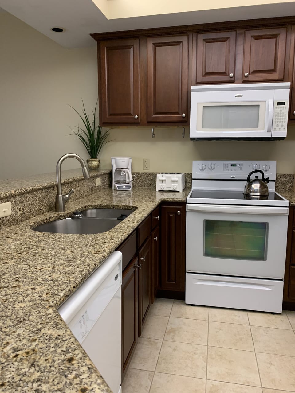 Kitchen showing large toaster and Mr. Coffee coffee maker.