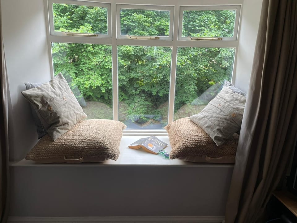 Enjoy a book or spot the local heron from the cosy riverside reading nook