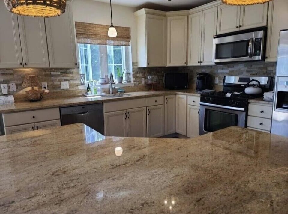 Open kitchen with granite countertops and brand new appliances.