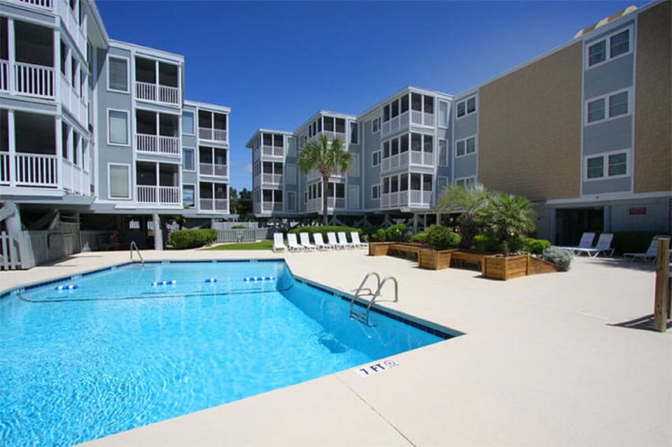 Take a cool dip in the sparkling pool after a fun day at the beach.
