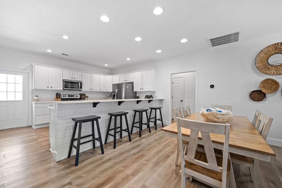 The large center island provides ample space for meal prep and casual dining, while the open floor plan allows for easy entertaining.
