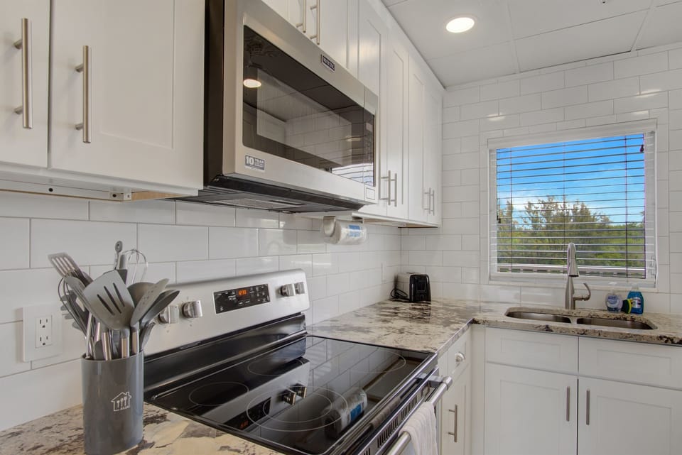 Renovated kitchen, fully stocked with cooking/eating/drinking utensils.
