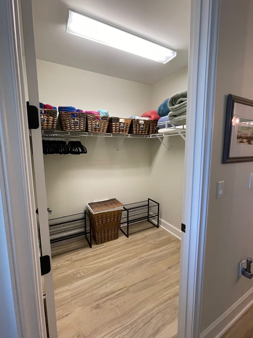 Huge walk-in closet in the Primary Suite with pool & beach towels, & extra linen