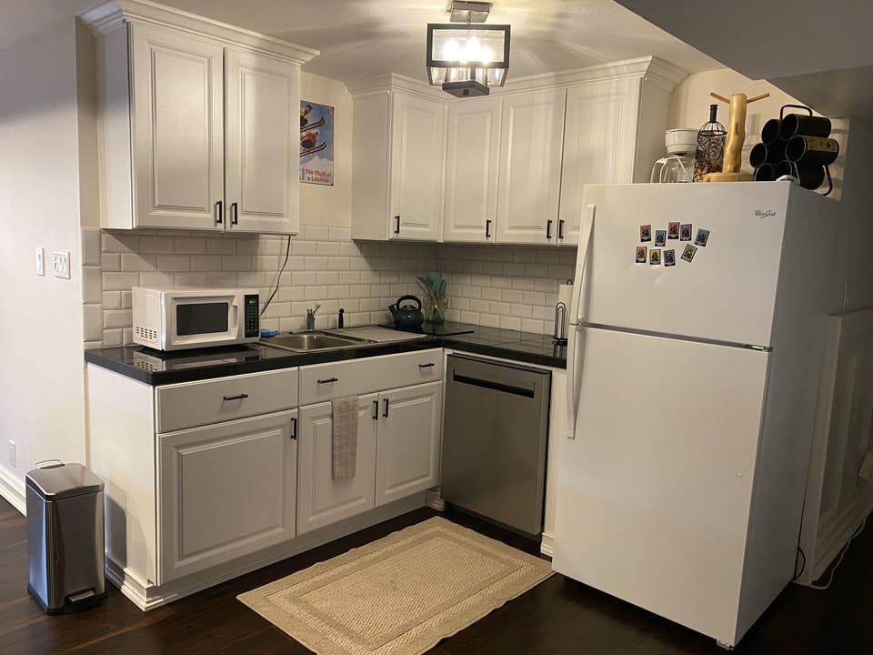 Kitchen with dishwasher, full fridge, 2 burner stove top,  coffee maker, etc. 