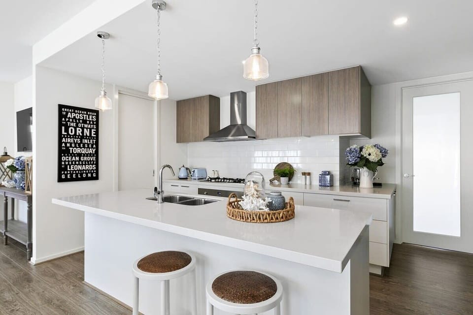 Prepare meals with ease in the stylish kitchen featuring top-notch appliances and stone bench tops