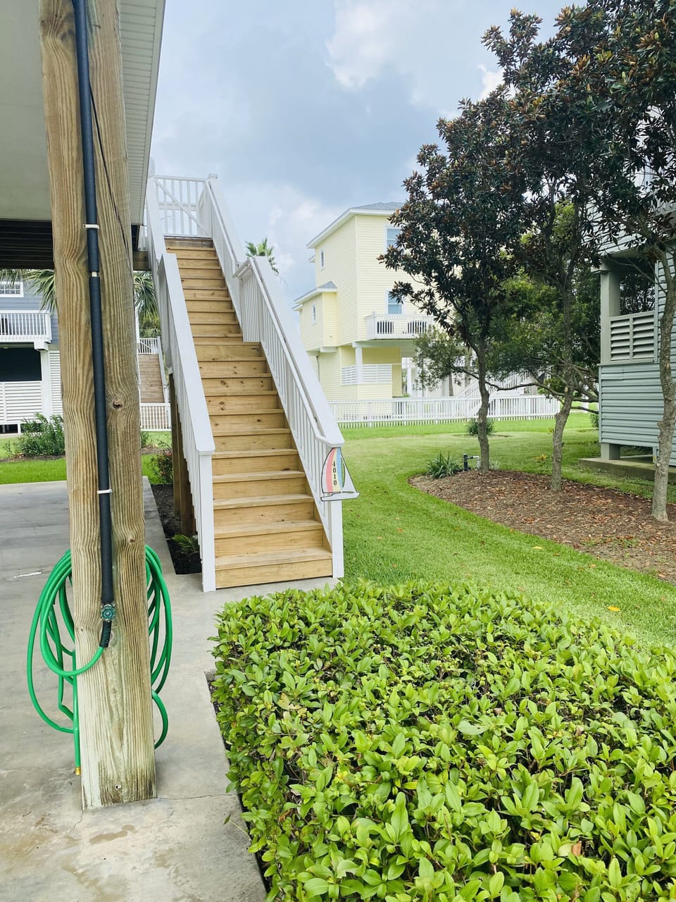 Stairs to main entrance-deck - two picnic tables and swings-