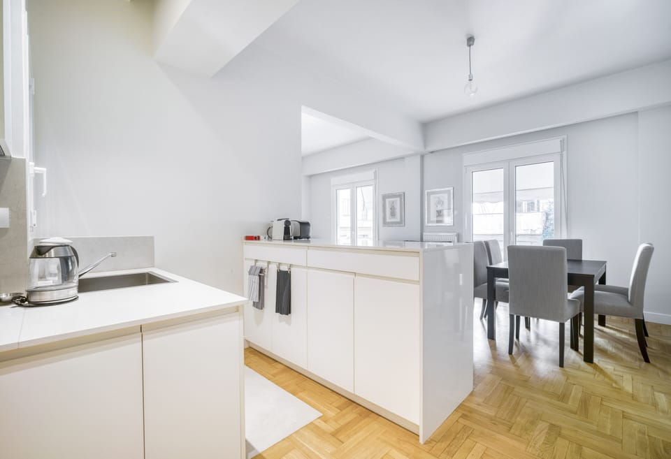 Kitchen with raised bar counter adjacent to dining area